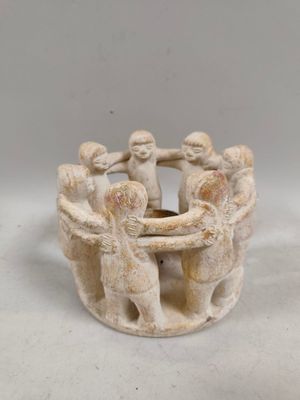 an image of a group of figurines holding hands