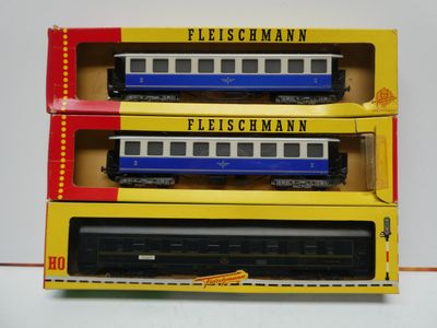 three boxed trains sitting on top of each other on a table