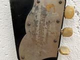 a close up of a guitar neck with a plaque on it