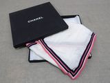 a black box with a white towel and a black box with a red and white stripe