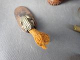 a small wooden spoon with a yellow string on it