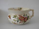 a white pitcher with a floral design on it
