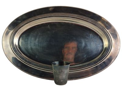 a reflection of a man in the mirror of a silver plate