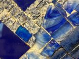 a close up view of a blue and white mosaic tile