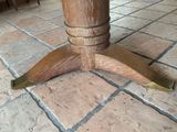 a close up of a wooden table on a tiled floor