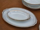 three plates and a bowl sitting on a table