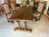 a large wooden table with chairs around it in a room