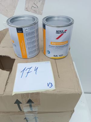 two cans of paint sitting on top of a cardboard box