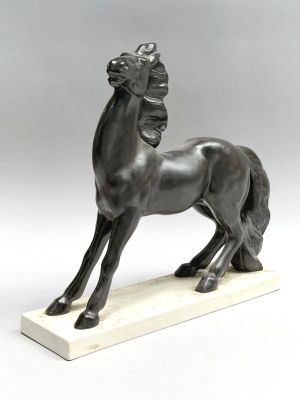 a bronze statue of a horse on a marble base
