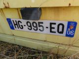 a close up of a license plate on a yellow truck