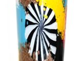 a colorful glass with a black, white, yellow, red, and blue design on it