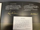 an open book with a handwritten letter and a picture of a man
