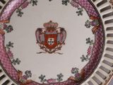 a plate with a coat of arms and a crown on it