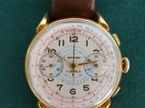 an image of a close up of a wrist watch on a green surface