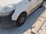 a small white van parked in a parking lot