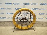 an image of a yellow hose sitting on top of a metal stand