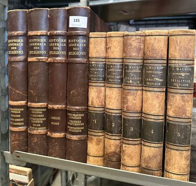 many old books on a shelf in a library