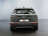 the rear end of a grey suv parked in a white room