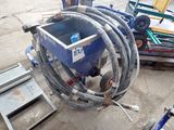 a picture of a blue machine with a hose attached to it