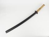 a close up of a samurai sword on a white surface