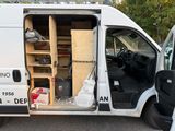 a white van with a door open in a parking lot