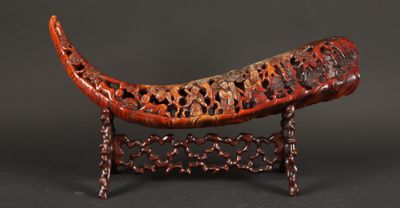 an image of a carved animal on a stand on a black background