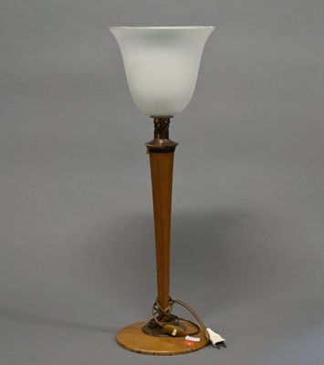 lamp with a wooden base and a frosted glass shade on a gray background