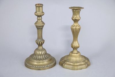 pair of antique brass candlesticks on a white background
