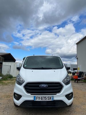 the front of a white ford transit van parked in a parking lot