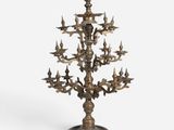 a large brass candelabra with birds on it