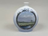 a white vase with a picture of a windmill on it
