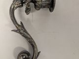 a metal hook that has a bird on it