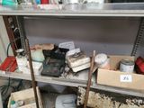 a metal shelf with a lot of items on it