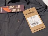 a tag that says smile skin on the back of a jacket