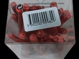 a plastic container filled with red hotdogs with a barcode on it