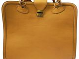 an image of a tan leather briefcase with a handle