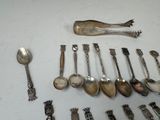 a lot of silver spoons and spoon spoons on the table