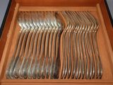 a lot of silverware in a box on the table