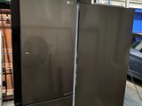 two refrigerators that are on the ground in a building