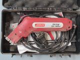 a red tool in a case with wires in it