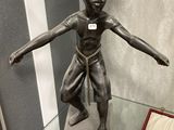 a statue of a boy that is on display in a glass case