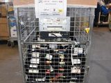 a metal cage filled with bottles of wine in a warehouse