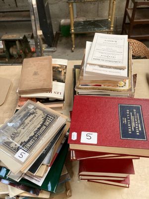 many books stacked on top of each other on a table