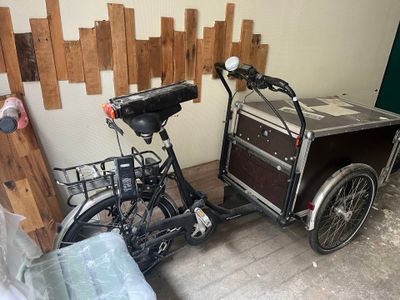 a bike with a cart attached to the back of it