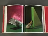 an open book with a picture of a pair of shoes and a purse