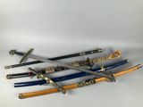four different types of samurai swords on a white surface