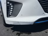 a close up of a white car with blue trims