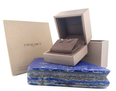 an image of a couple of rings sitting on top of a blue stone