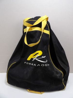 a black bag with a yellow handle on a white table