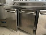 a kitchen with stainless steel appliances in the middle of the floor